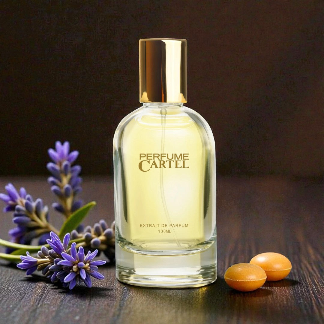 Perfume Cartel bottle with lavender and oranges on a wooden surface