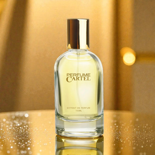 Perfume Cartel bottle on a reflective gold surface with a blurred gold background