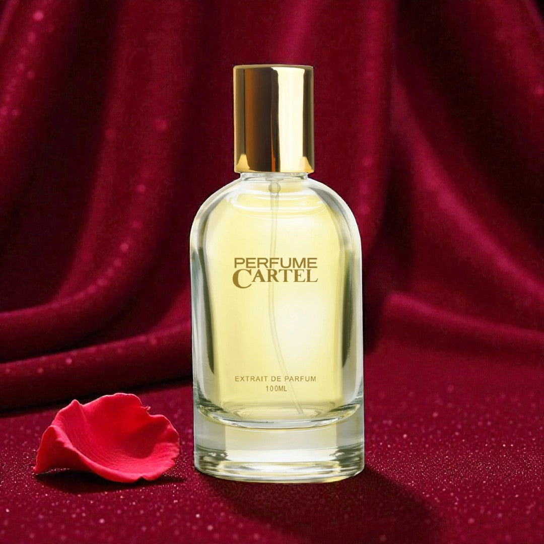 Perfume Cartel bottle with gold cap on a red fabric background