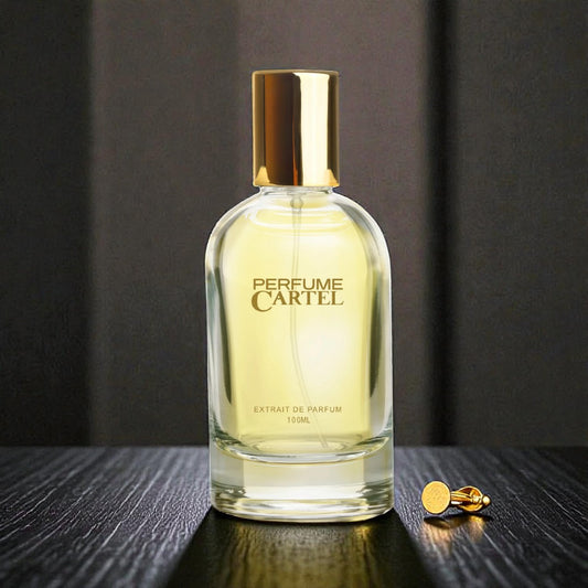 Perfume Cartel bottle with gold cap and earring on a dark surface