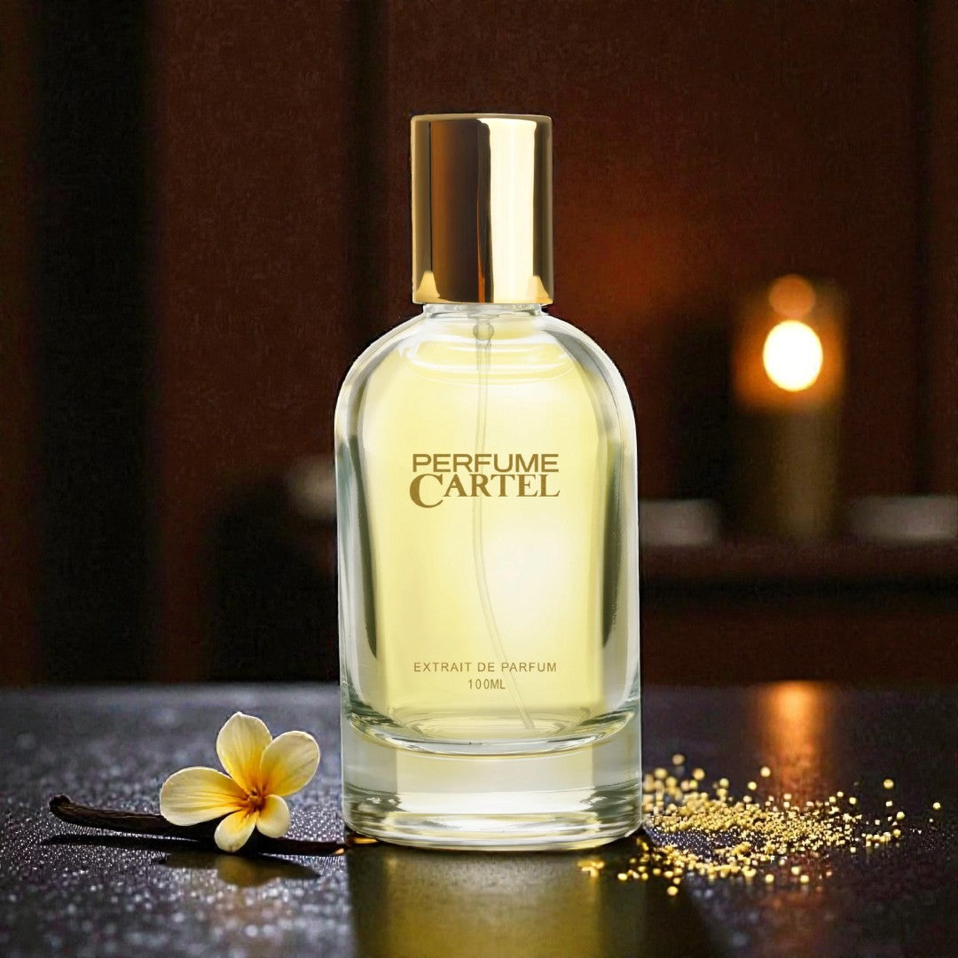 Perfume Cartel bottle with a gold cap on a dark surface with a blurred background