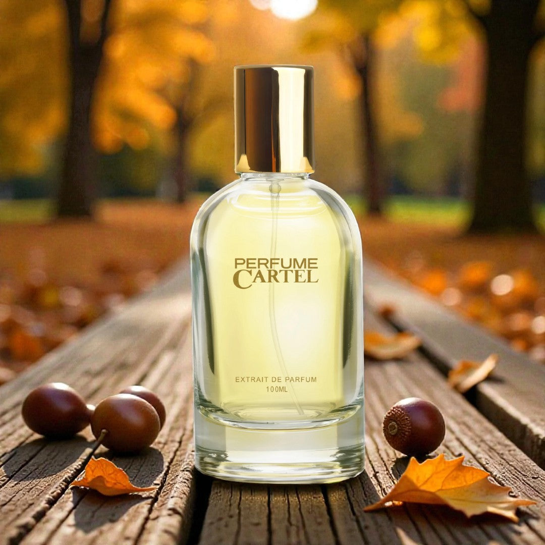 Perfume Cartel bottle on a wooden surface with autumn leaves and background