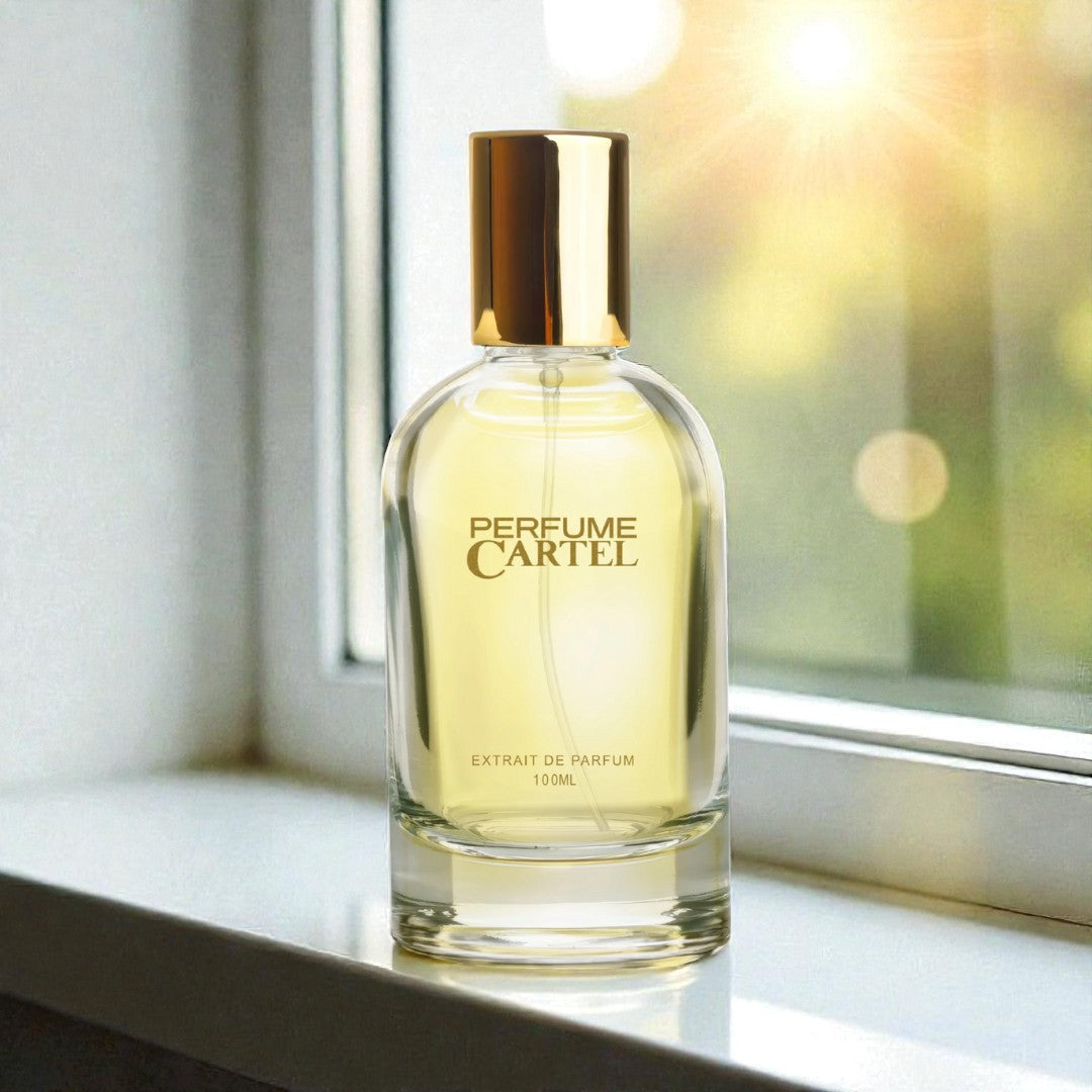 Perfume Cartel bottle on a windowsill with a blurred outdoor background