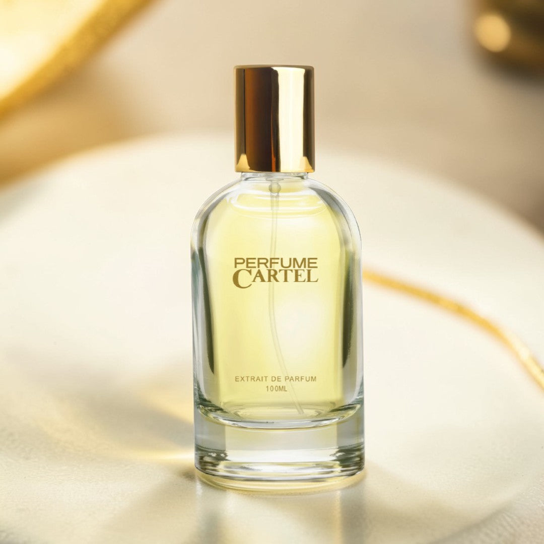 Perfume Cartel bottle on a reflective surface with a blurred background