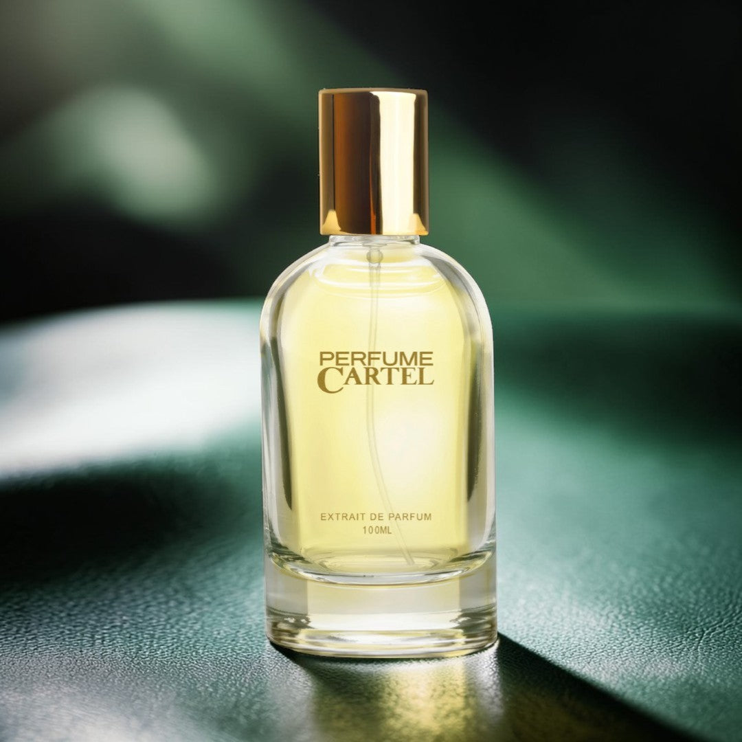 Perfume Cartel bottle on a reflective surface with a blurred green background