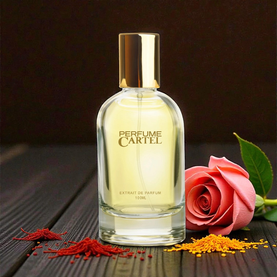 Perfume Cartel bottle with a pink rose on a dark wooden surface