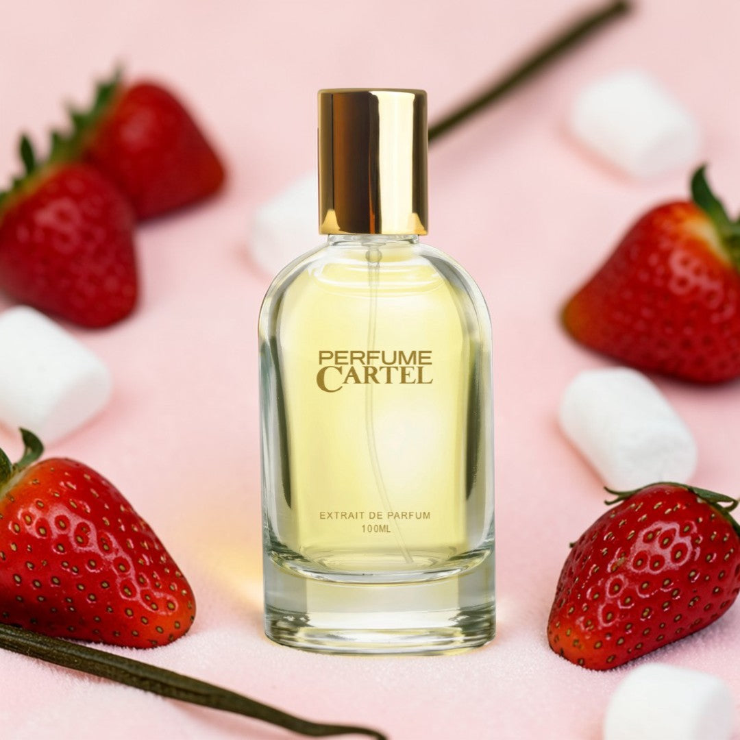Perfume Cartel bottle with strawberries and vanilla beans on a pink background