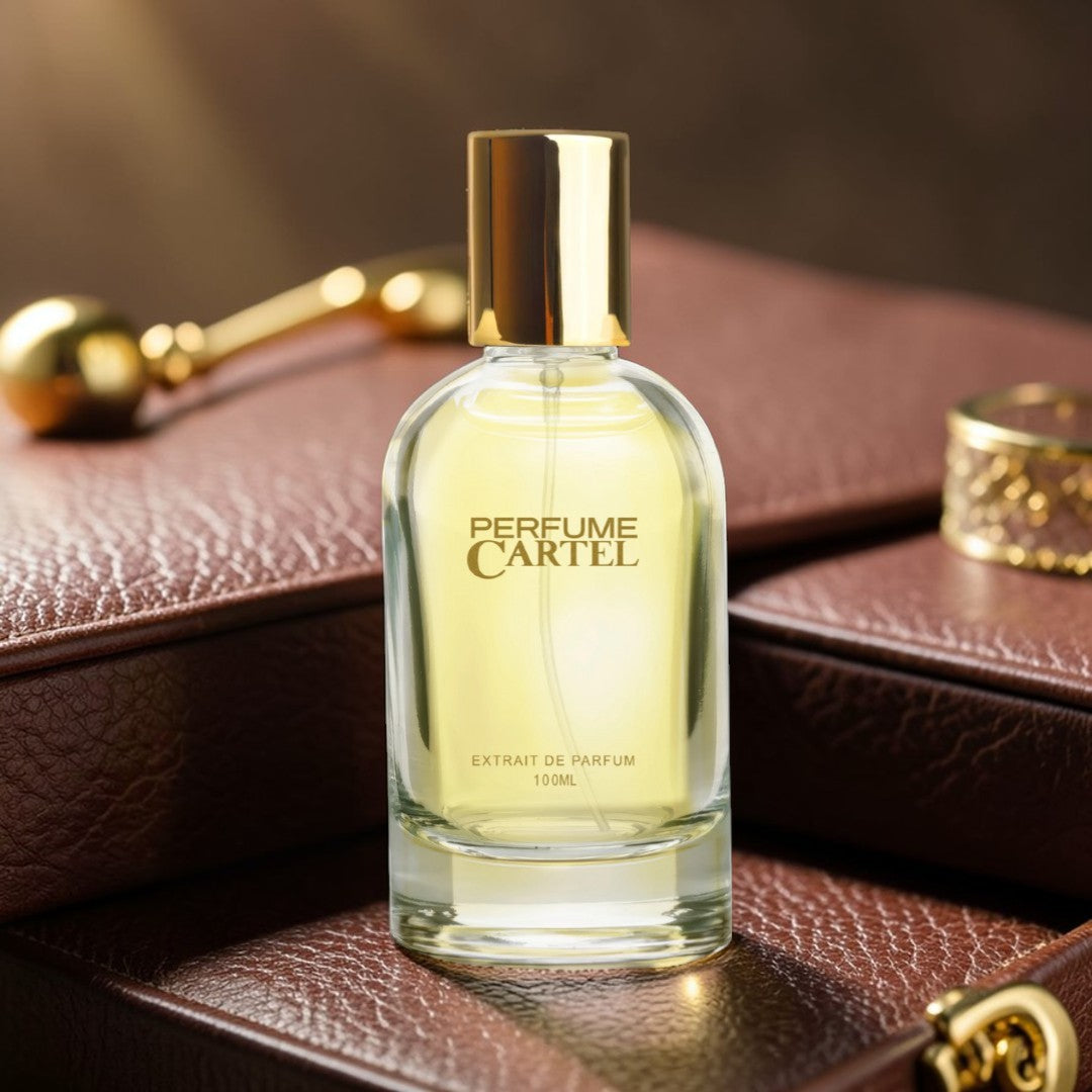 Perfume Cartel bottle on a brown leather surface with gold accents