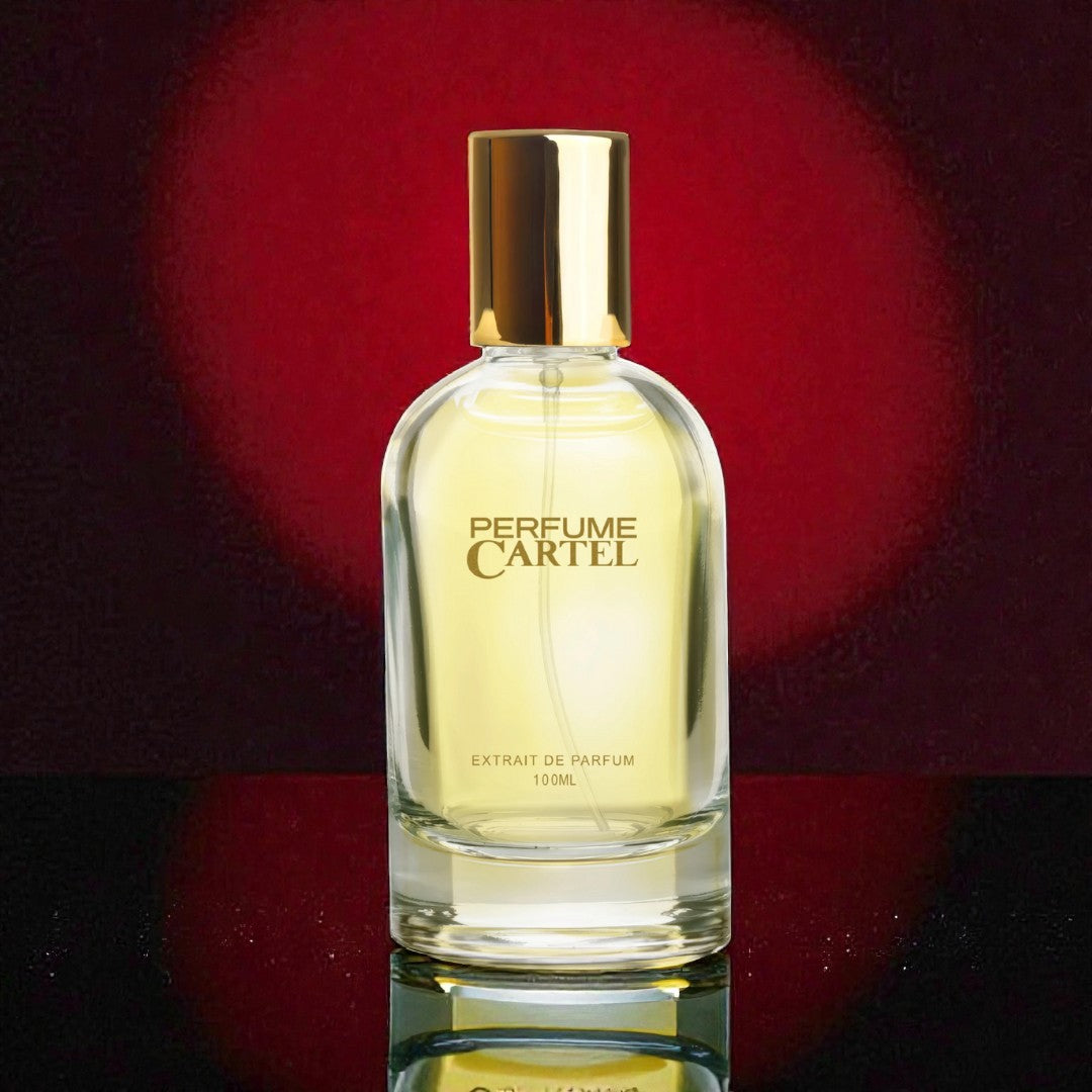 Perfume Cartel bottle on a reflective surface with a red blurred background