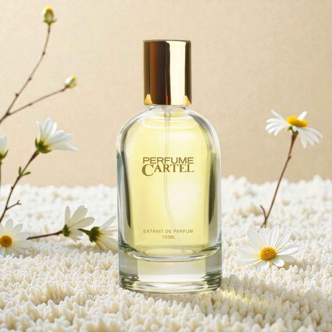 Perfume Cartel bottle with gold cap on a beige background with flowers